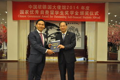 Mr. Shi Mingde, the Chinese ambassador (right) handing Hai Wang (left) his award.